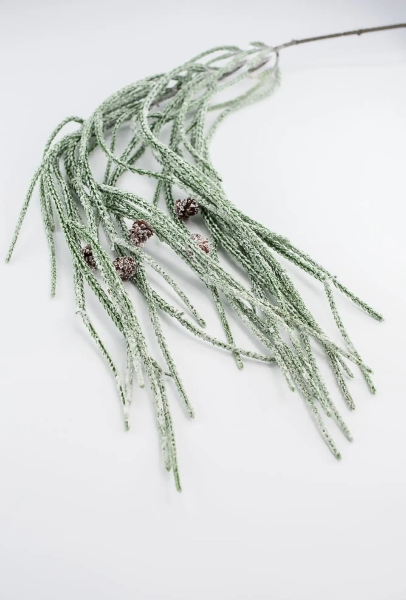 Artificial, frosted, weeping greenery branch